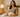 Confident woman sitting on a sunlit bed with a discreet modern vibrator on the bedside table, symbolizing sex positivity and self-love