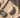 Discreet couples vibrator placed on soft neutral fabric in a minimalist, elegant style.