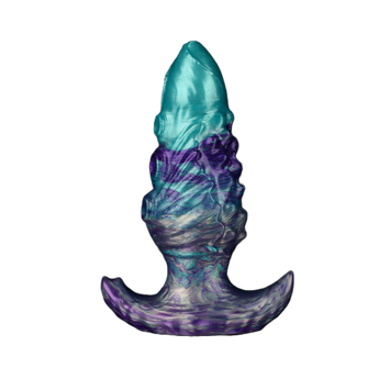Artistic anal plug featuring textured multicolor silicone in teal and violet shades with ergonomic base.
