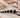 Generic anal beads with a retrieval loop, lubricant, and storage pouch on a neutral surface
